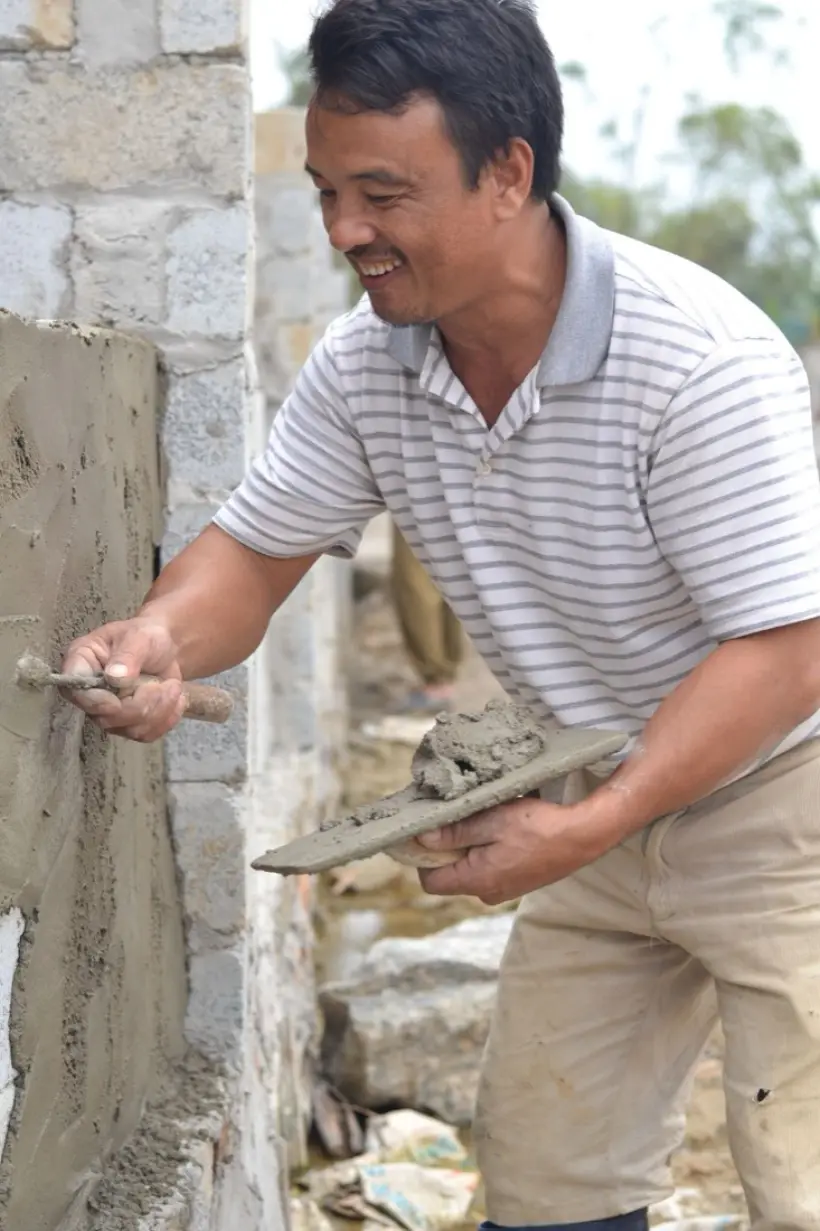 Plasterer smoothing a wall with a trowel